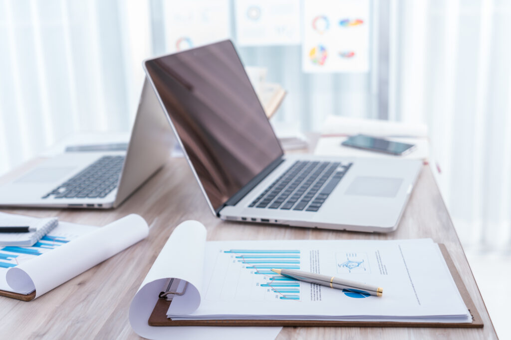 Financial charts on the table with laptop